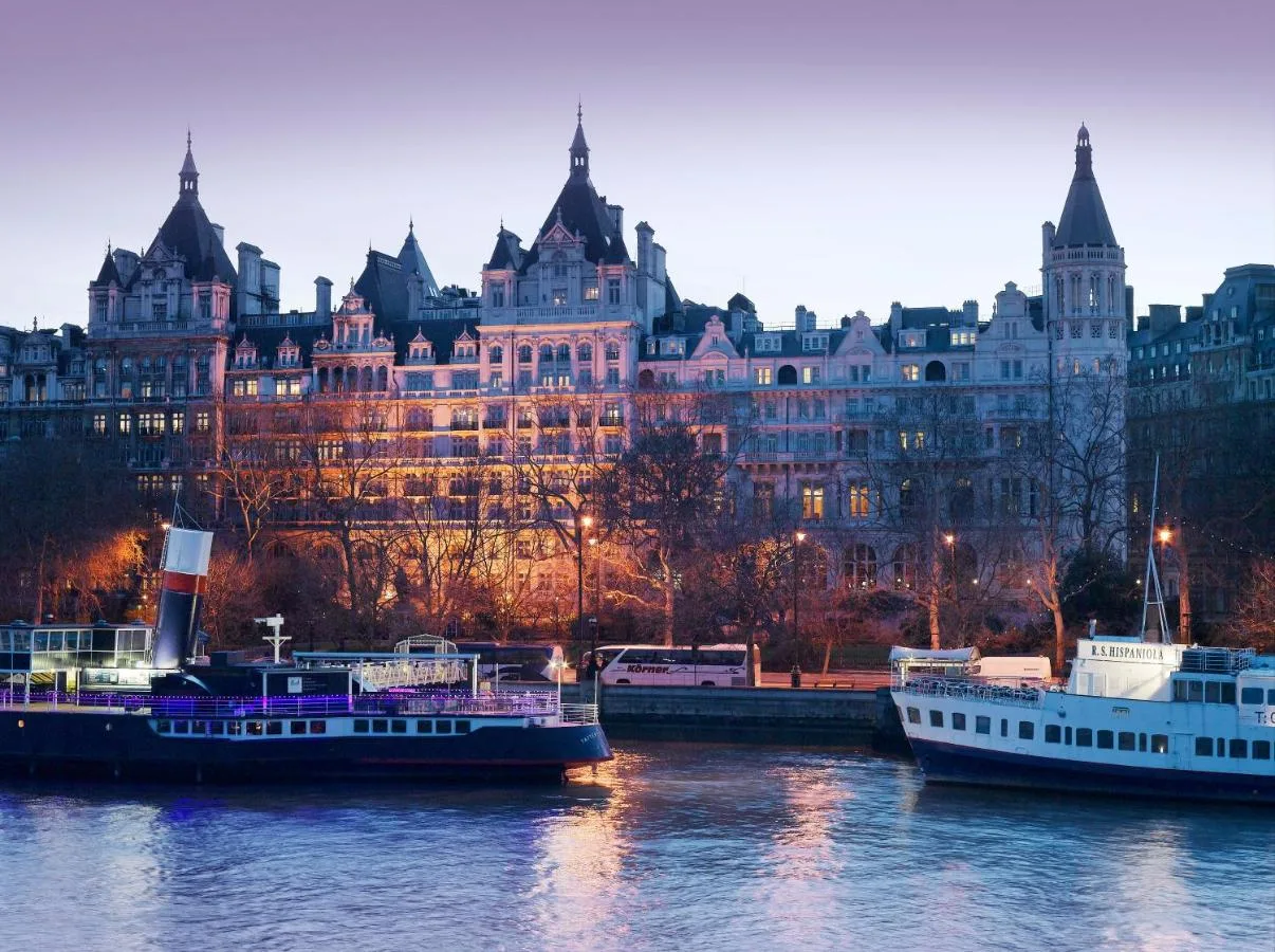 a group of boats in the water in front of a large building at The Royal Horseguards Hotel, London in London