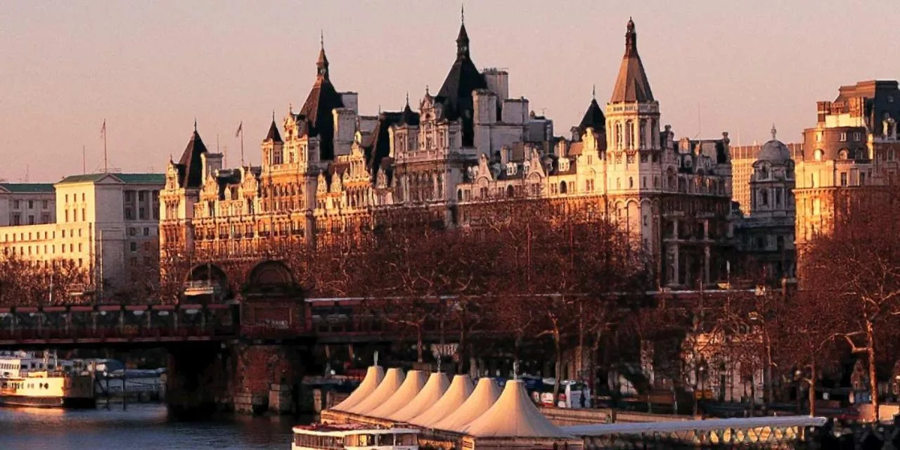 a large building with a bridge over a river at The Royal Horseguards Hotel, London in London