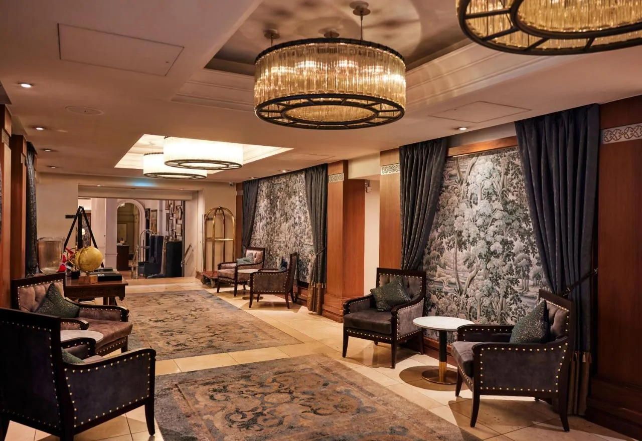 a lobby with chairs and a waiting room at The Royal Horseguards Hotel, London in London